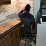 Derek working on kitchen subway tile installation