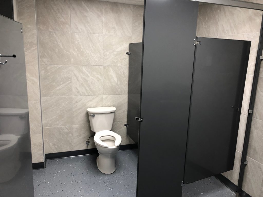 Professional remodeling contractors finished industrial bathroom with tiled walls