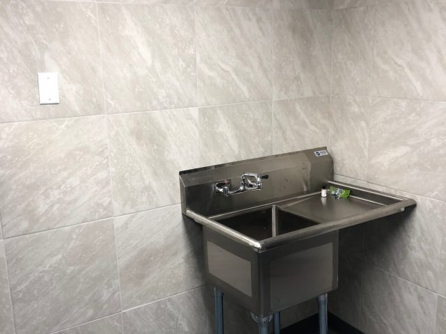 Professional remodeling contractors finished industrial bathroom with tiled walls