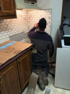 Derek working on kitchen subway tile installation